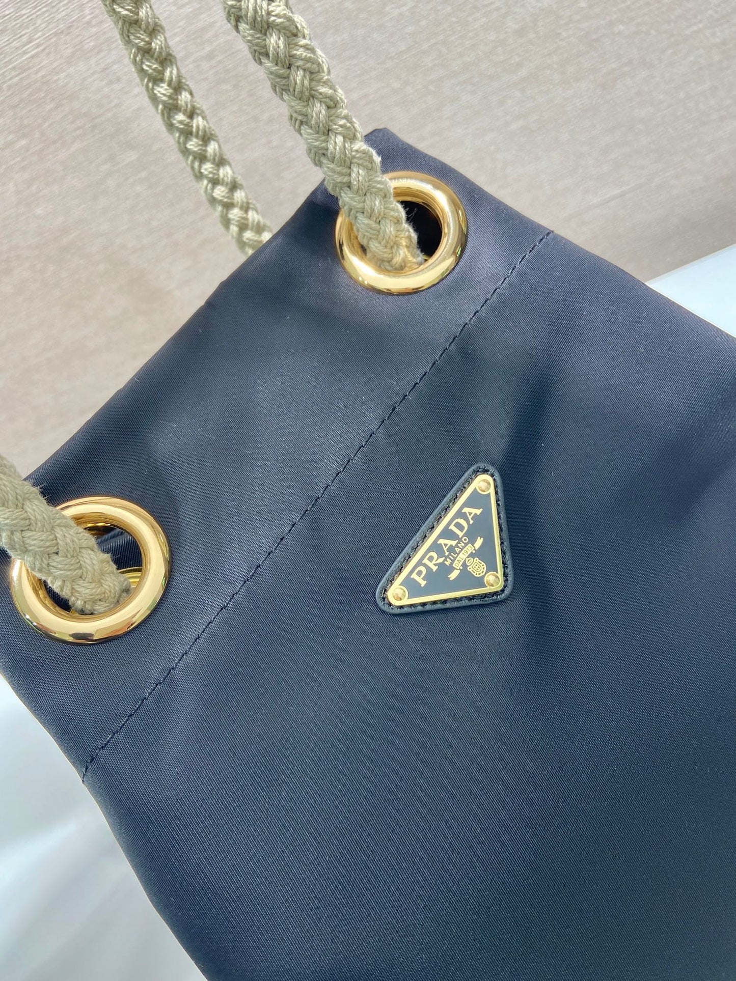 PRADA BUCKET BAG 28 IN BLACK RE-NYLON GOLD LOGO