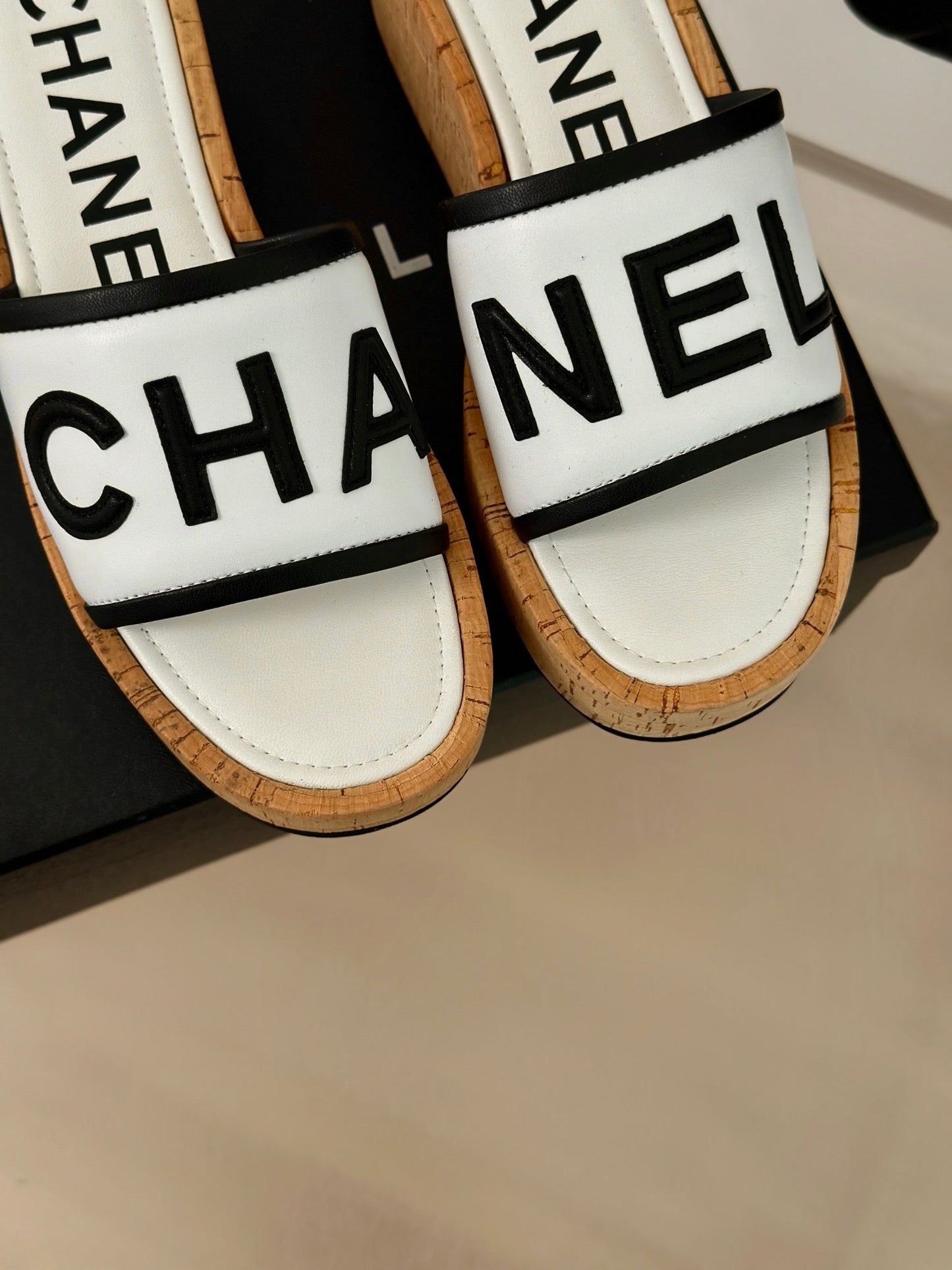 CHANEL THICK SOLE LETTER SLIPPERS IN WHITE SHEEPSKIN